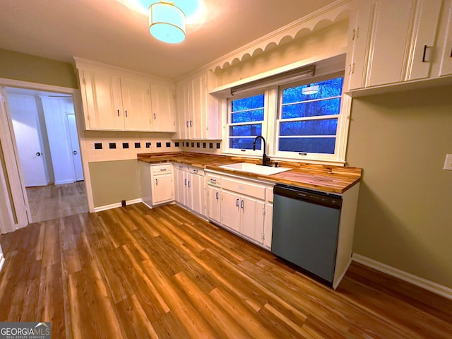 kitchen featuring dark hardwood / wood-style flooring, tasteful backsplash, stainless steel dishwasher, sink, and white cabinetry