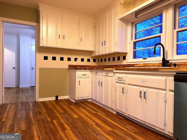 kitchen featuring dark hardwood / wood-style flooring, white cabinets, and sink