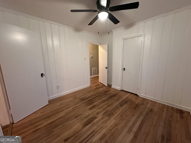 unfurnished bedroom featuring ceiling fan and dark wood-type flooring