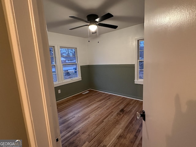 spare room featuring hardwood / wood-style flooring and ceiling fan