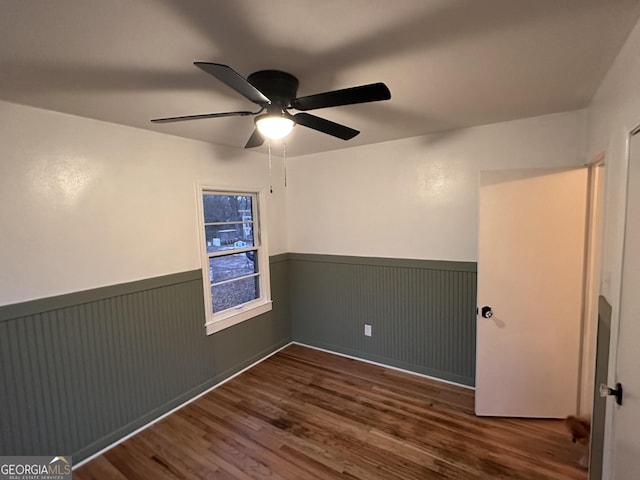 unfurnished room featuring ceiling fan and dark hardwood / wood-style floors