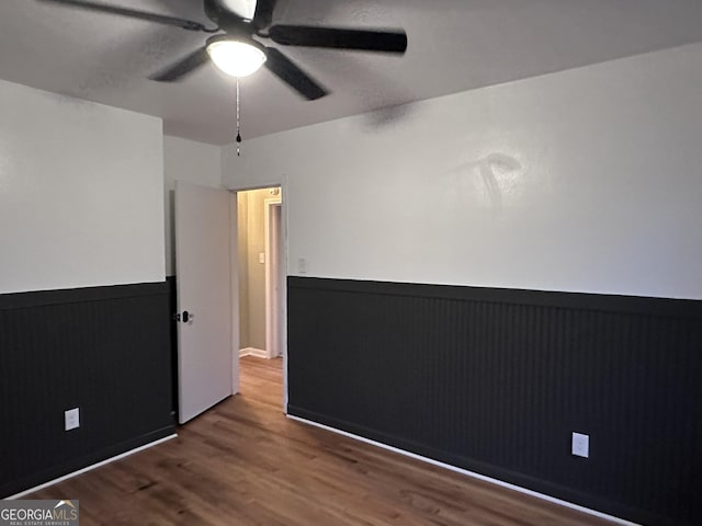 unfurnished room with hardwood / wood-style flooring and ceiling fan