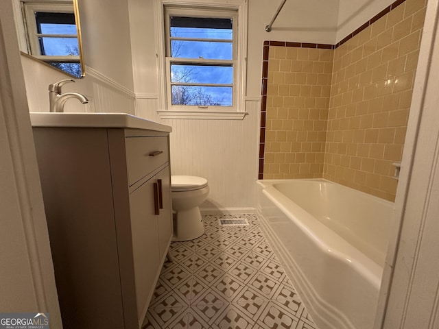 full bathroom featuring vanity, toilet, and tiled shower / bath combo