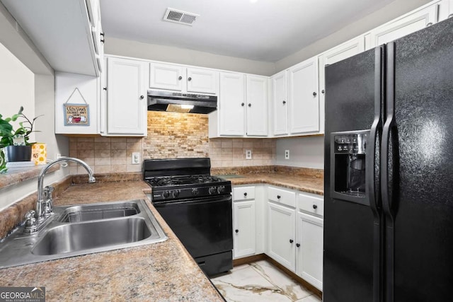 kitchen with black appliances, backsplash, white cabinetry, and sink