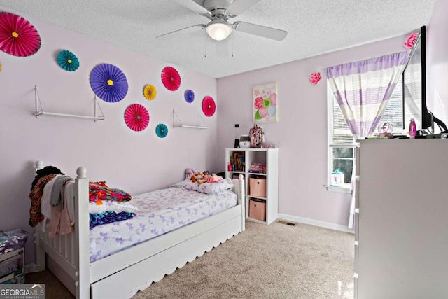 carpeted bedroom with a textured ceiling and ceiling fan