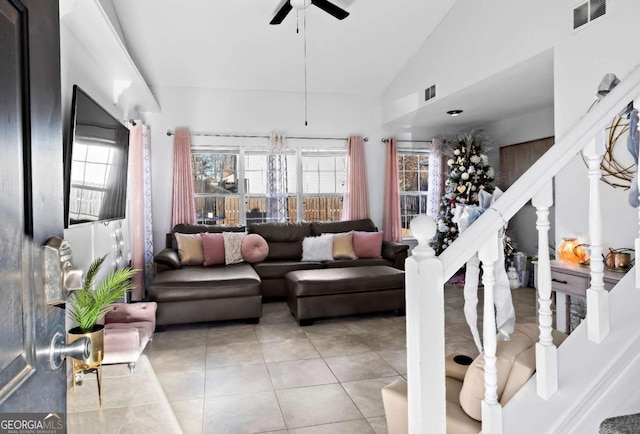 tiled living room with ceiling fan and lofted ceiling