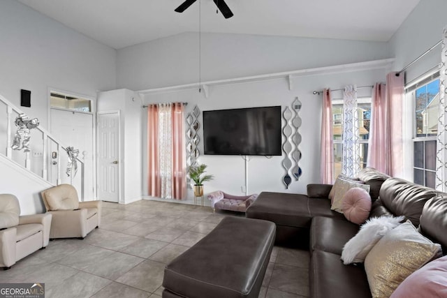 tiled living room featuring ceiling fan and high vaulted ceiling