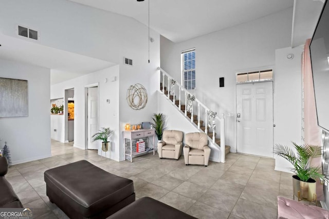 living room featuring high vaulted ceiling