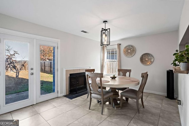 tiled dining area featuring a tiled fireplace