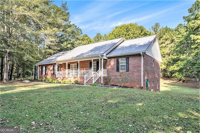 single story home featuring covered porch and a front yard