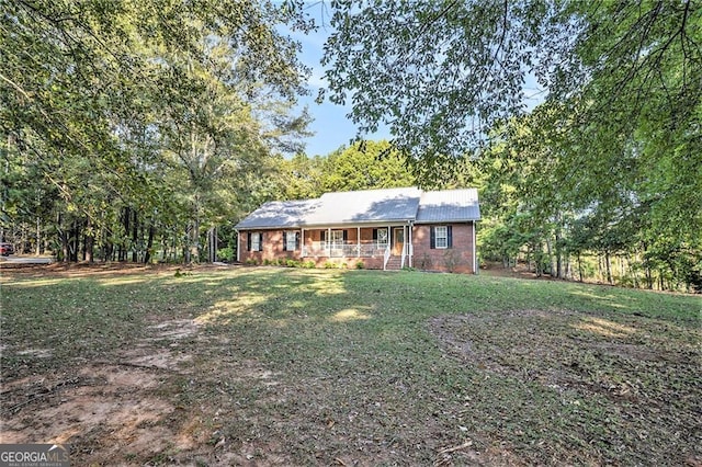 ranch-style home featuring a front yard and a porch