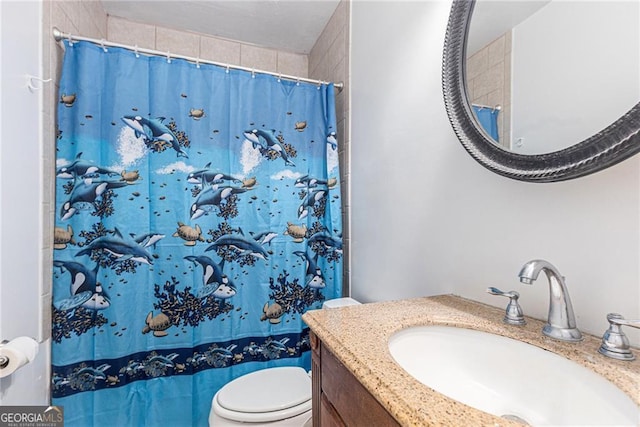 bathroom featuring vanity, a shower with shower curtain, and toilet