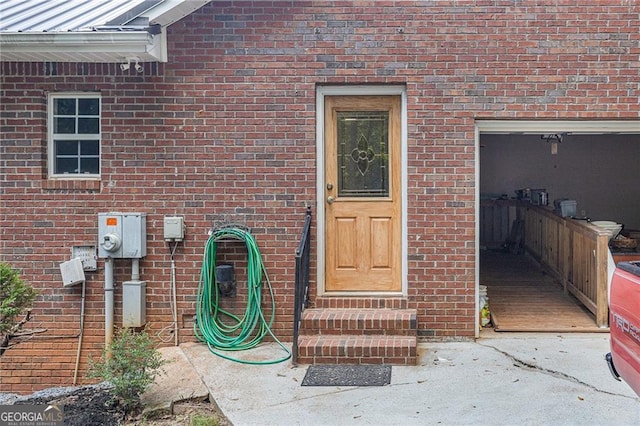 doorway to property with a garage