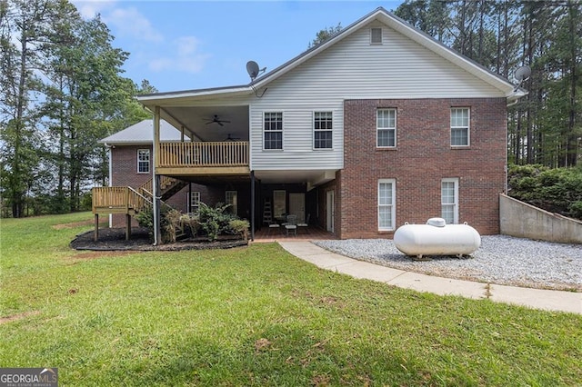 back of house with ceiling fan, a patio area, a deck, and a yard