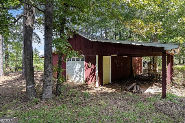 view of outbuilding with a carport and a garage