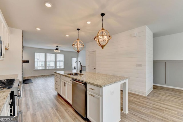 kitchen with white cabinetry, a center island with sink, sink, and appliances with stainless steel finishes