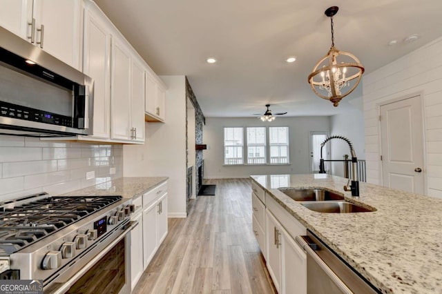 kitchen featuring white cabinetry, sink, and appliances with stainless steel finishes