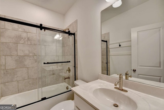 full bathroom featuring toilet, vanity, and combined bath / shower with glass door