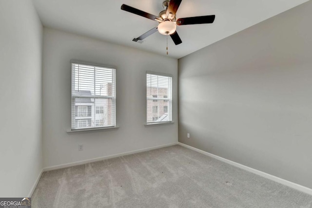 spare room with light carpet and ceiling fan