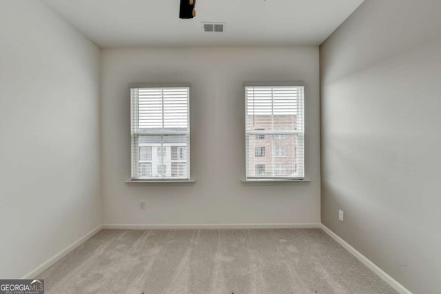 carpeted empty room featuring a wealth of natural light