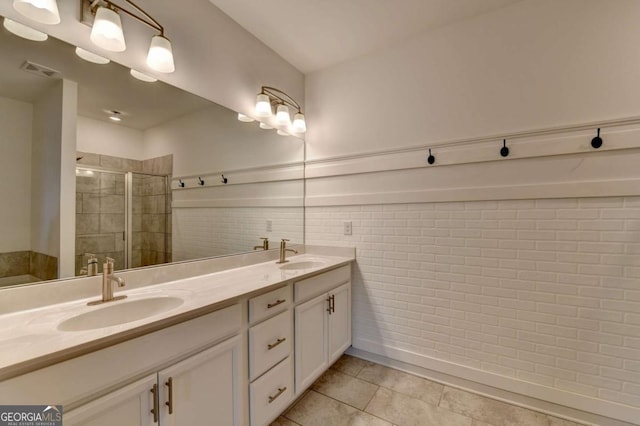 bathroom with tile patterned floors, vanity, and an enclosed shower