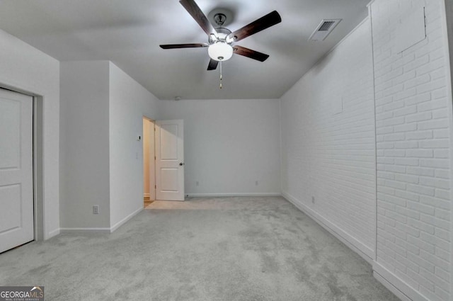 interior space with ceiling fan and light colored carpet