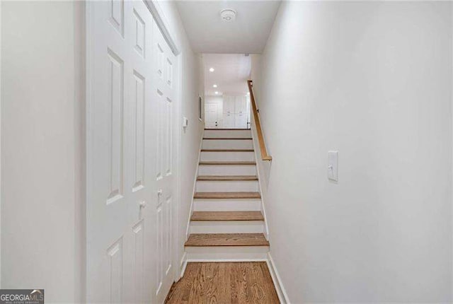 stairs featuring wood-type flooring