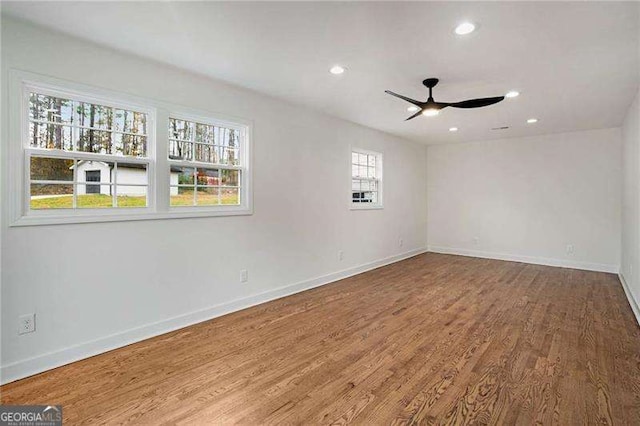 empty room with ceiling fan and wood-type flooring