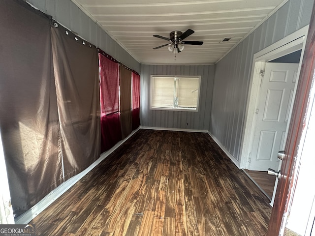 unfurnished room with ceiling fan and dark hardwood / wood-style flooring