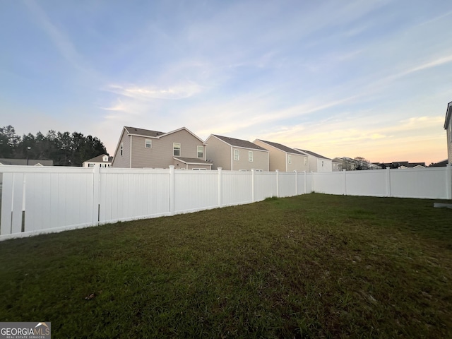 view of yard at dusk