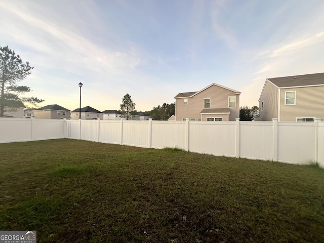 view of yard at dusk