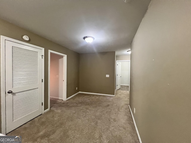 hallway featuring light carpet