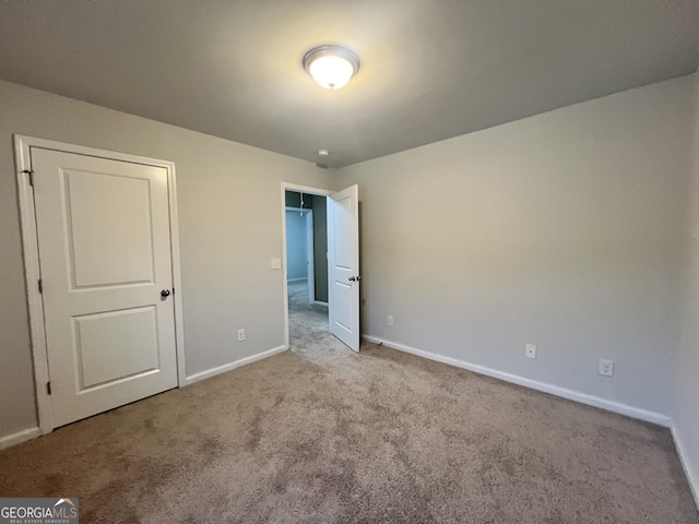 unfurnished bedroom featuring light carpet