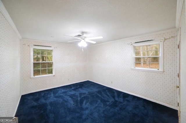 carpeted empty room featuring ceiling fan and ornamental molding