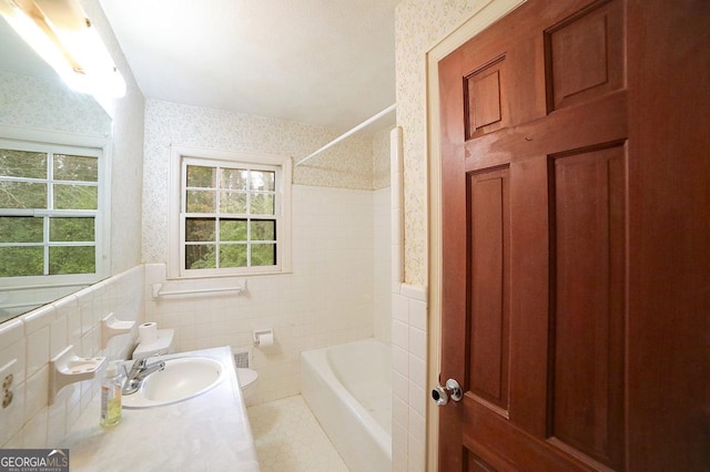 full bathroom with shower / bath combination, vanity, tile walls, tile patterned flooring, and toilet