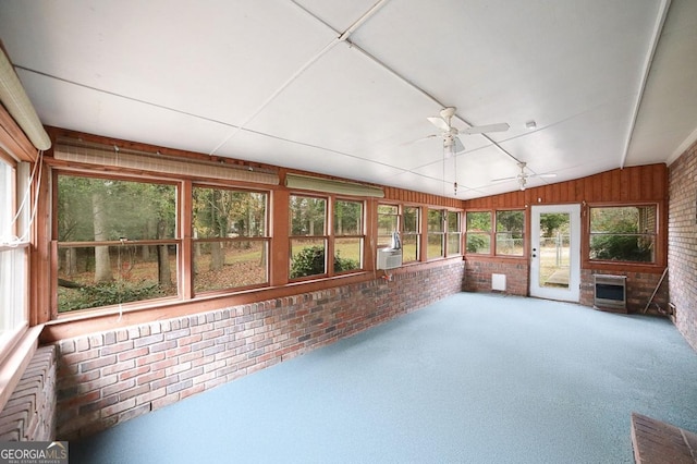 unfurnished sunroom with cooling unit, heating unit, ceiling fan, and lofted ceiling