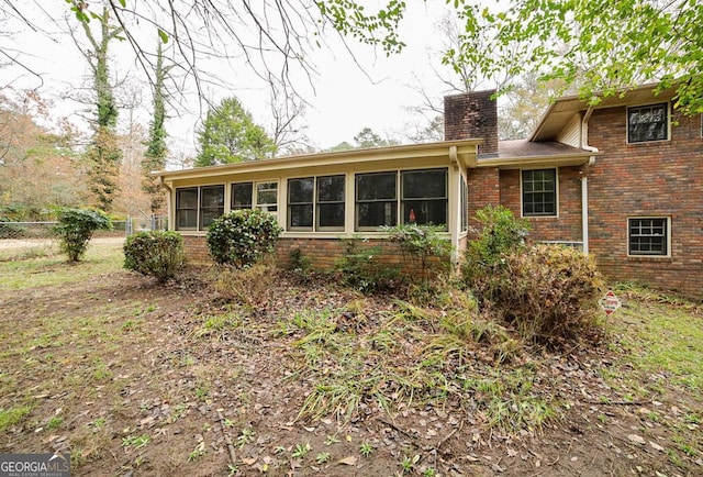 back of house with a sunroom