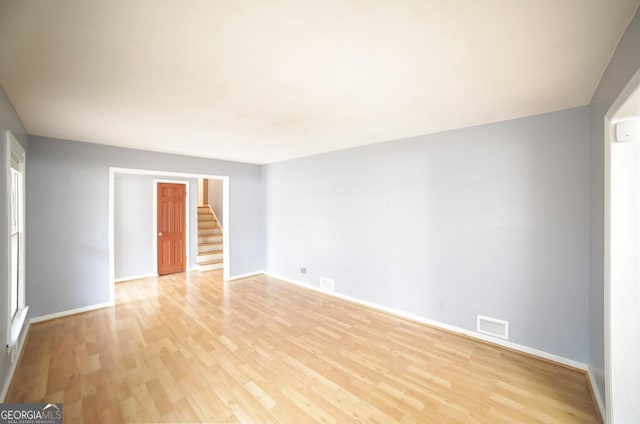 unfurnished room with light wood-type flooring