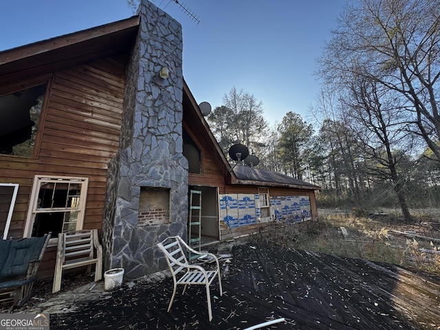 view of side of home featuring a wooden deck