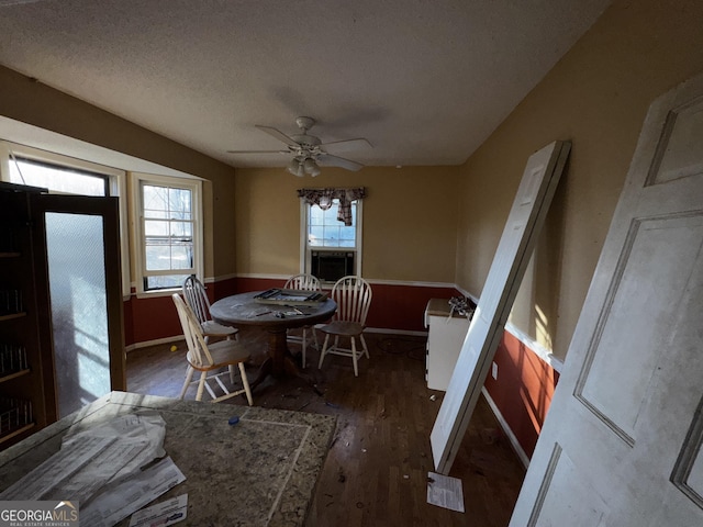 dining space featuring a textured ceiling, ceiling fan, a healthy amount of sunlight, and dark hardwood / wood-style floors