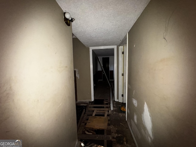 hall with a textured ceiling