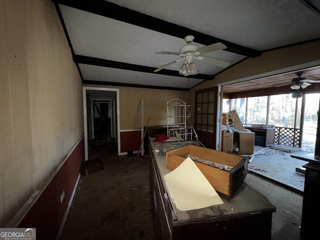 interior space featuring ceiling fan and lofted ceiling with beams