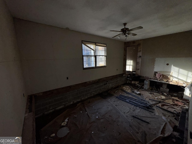 interior space with ceiling fan and a textured ceiling