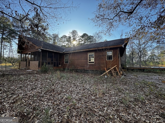 rear view of property with a sunroom