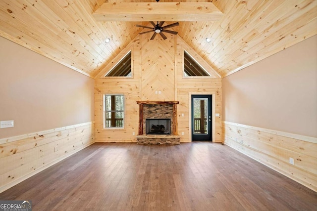 unfurnished living room featuring hardwood / wood-style flooring, beam ceiling, wood ceiling, and a fireplace