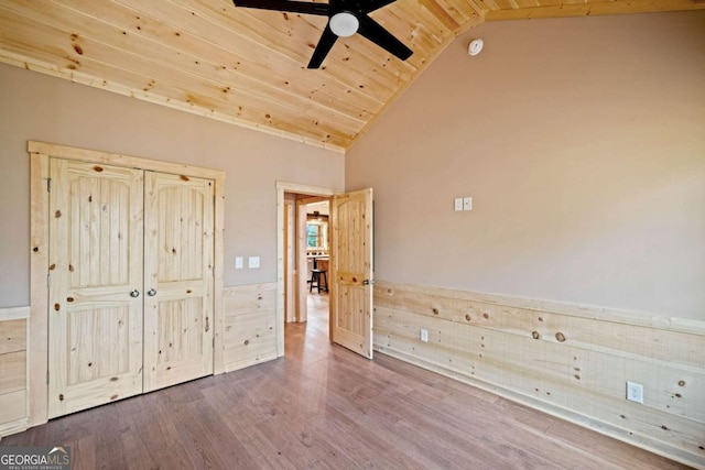 unfurnished bedroom with hardwood / wood-style flooring, high vaulted ceiling, ceiling fan, and wood ceiling