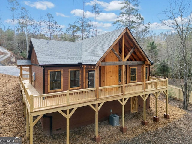 rear view of property with central AC unit and a wooden deck