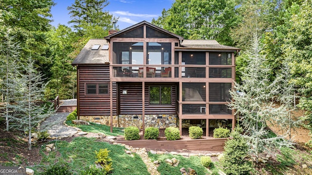 back of house with a sunroom