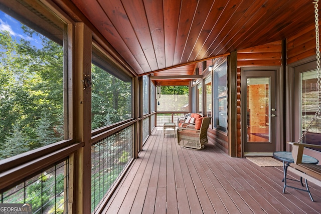 unfurnished sunroom with wooden ceiling, plenty of natural light, and lofted ceiling