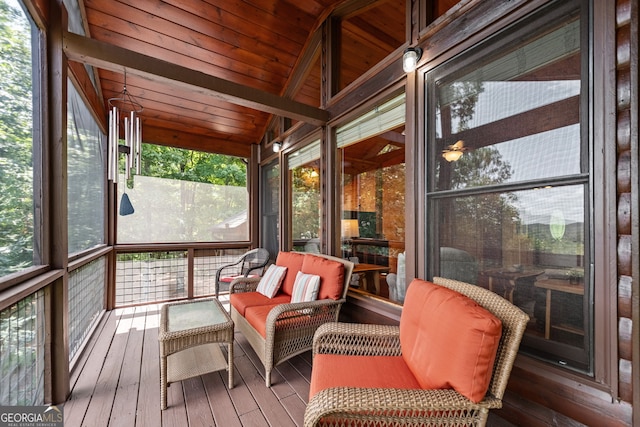 sunroom / solarium featuring lofted ceiling with beams and wooden ceiling